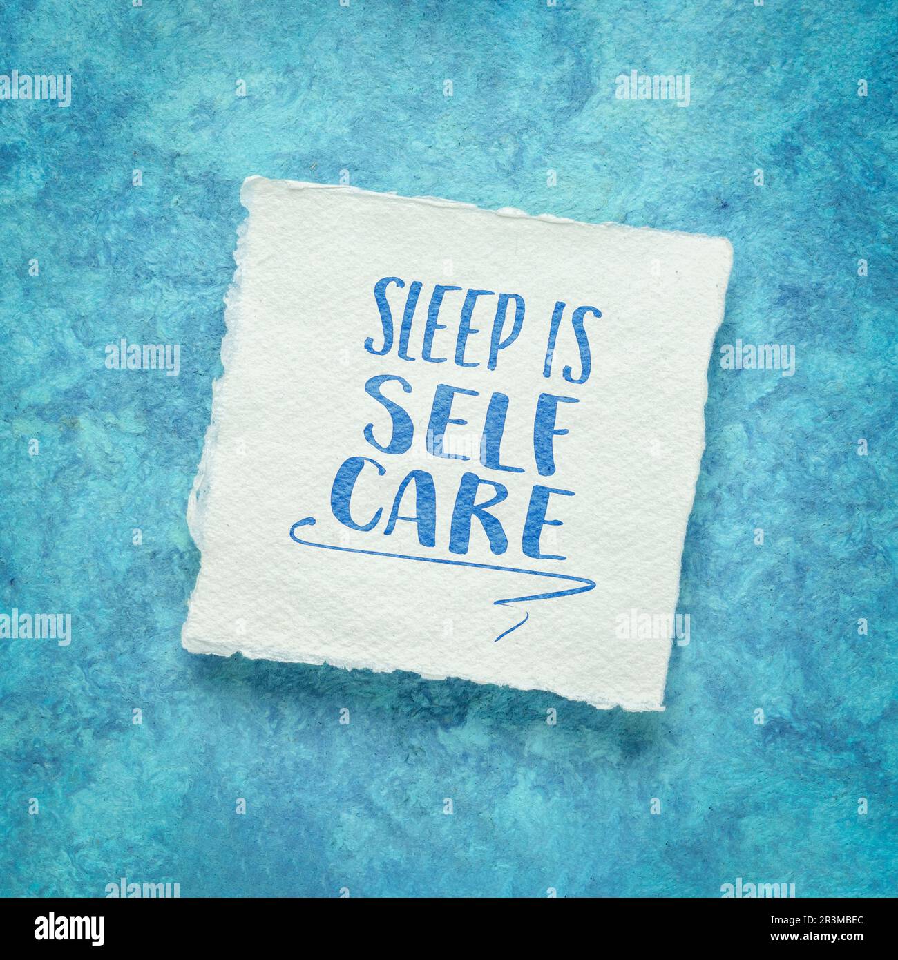 sleep is self care - inspirational reminder note on an art paper, healthy lifestyle concept Stock Photo