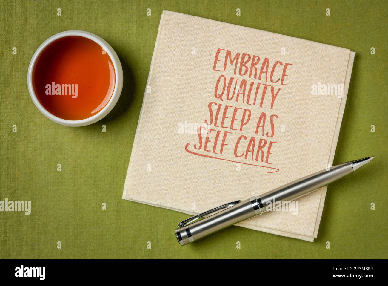 embrace quality sleep as self care - inspirational note on a napkin, healthy lifestyle and personal development concept Stock Photo