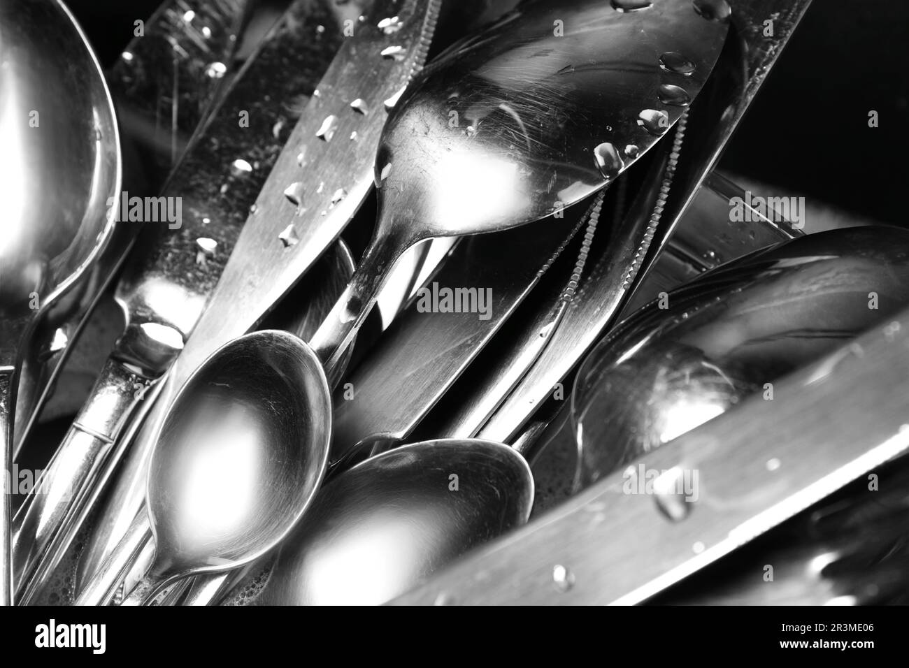 Washing silver spoons, forks and knives, closeup Stock Photo Alamy