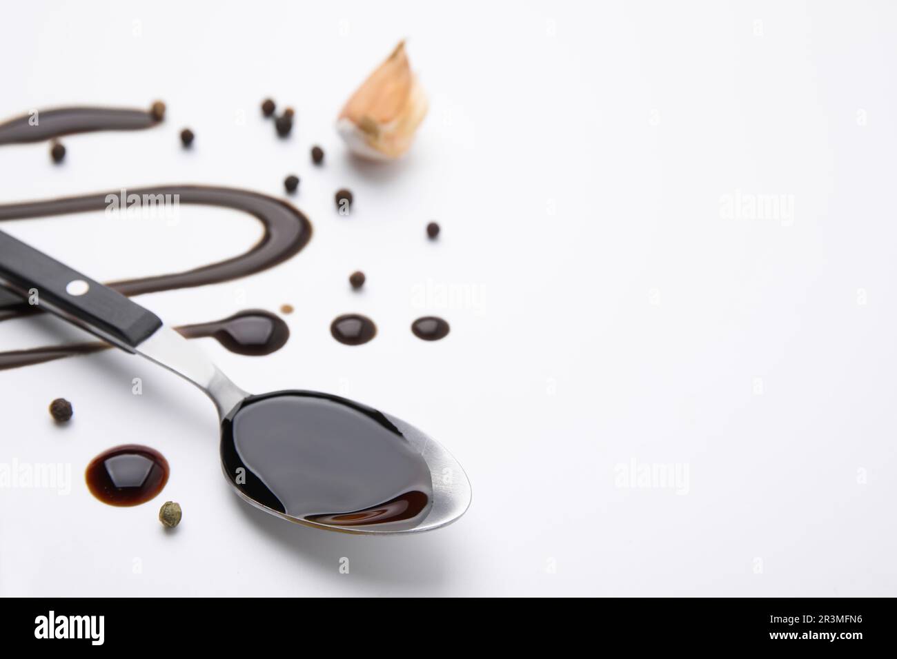 Organic balsamic vinegar and cooking ingredients on white background. Space for text Stock Photo