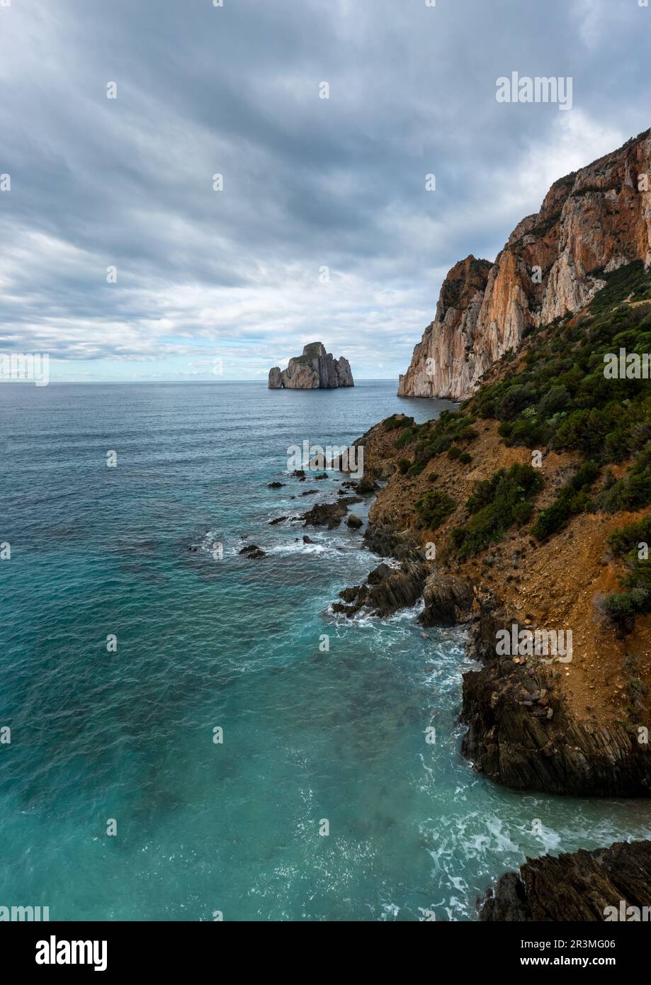 Vertical landscape of the cliffs and sea stacks at Porto Flavia on Sardinia Stock Photo