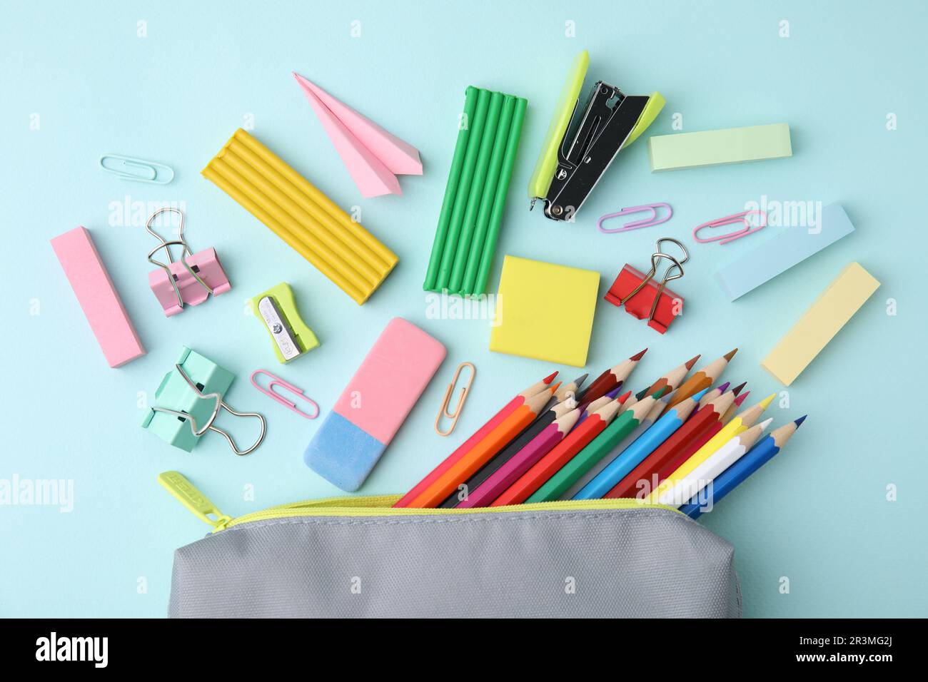Flat lay composition with school stationery on light blue background ...