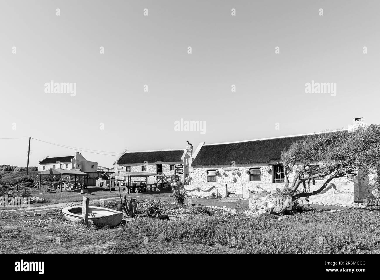 Arniston, South Africa - Sep 22, 2022: A street scene, with Willeens Art Craft and Restaurant, and Kassiesbaai Guest House, in Kassiesbaai, Arniston. Stock Photo