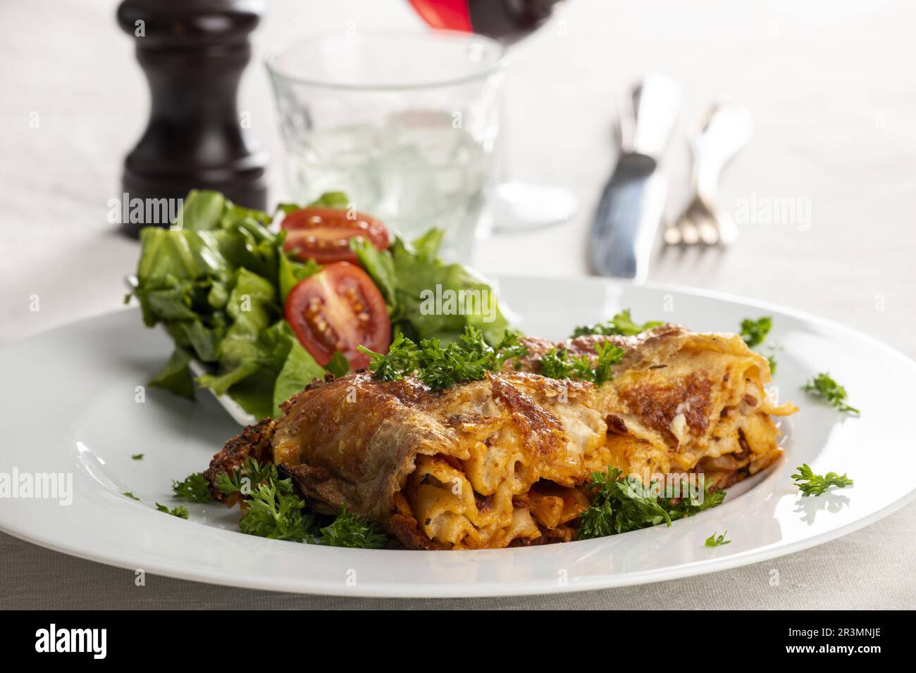 Portion of lasagna on a white plate Stock Photo