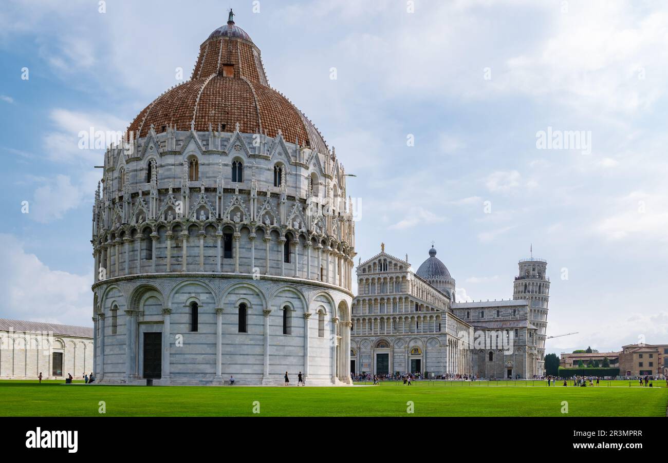 Leaning tower of Pisa Italy with Basilica Cathedral on a bright summer day with green grass Stock Photo