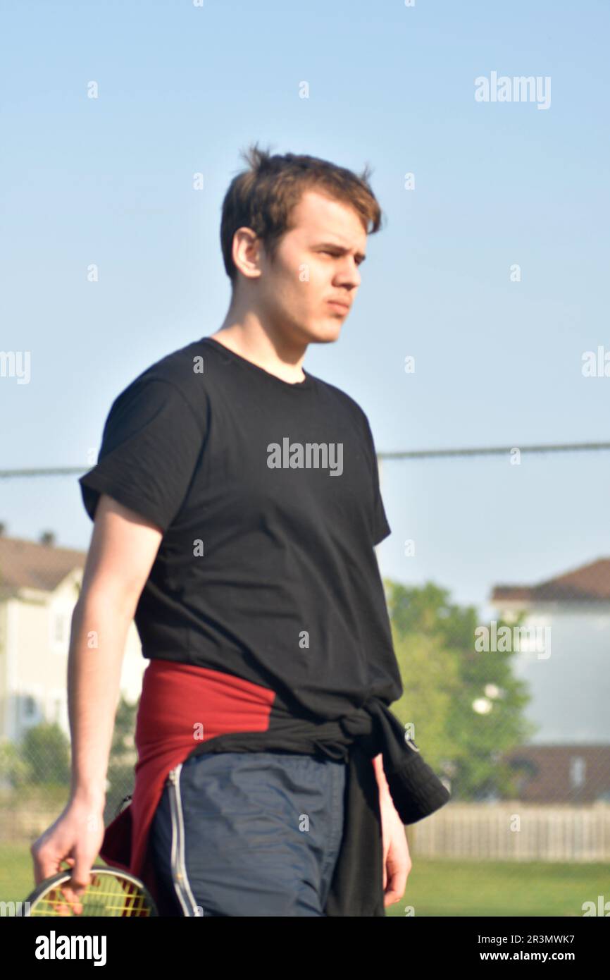 Half body portrait of young teenage handsome man wearing casual sport clothes Stock Photo