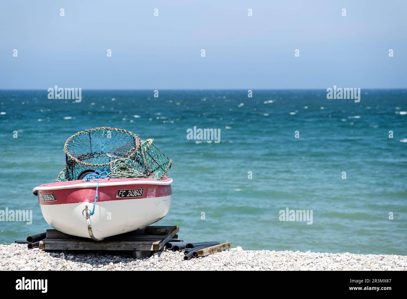 Yport, the pebbles beach, the small boat and the cliffs in front of the ...