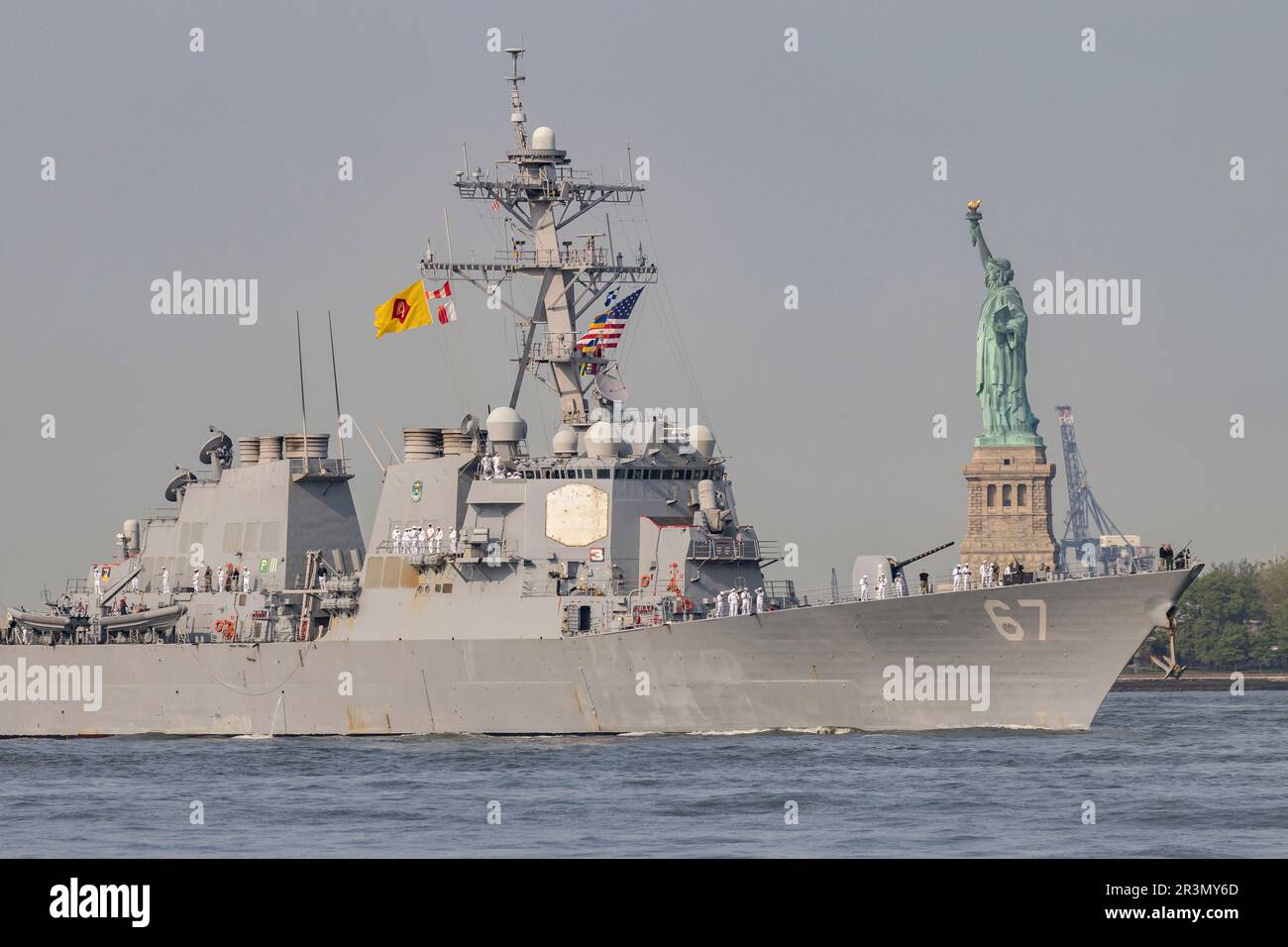 U.S. Sailors and Marines stand on the deck of the USS Cole, a guided ...