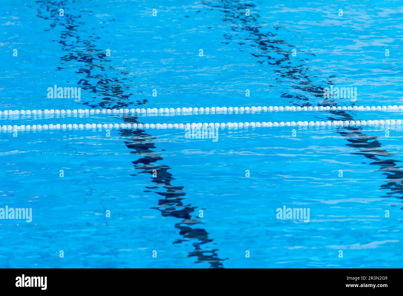 The view of an empty public swimming pool indoors. Lanes of a competition swimming pool. Horizontal sport theme poster, greeting cards, headers, websi Stock Photo