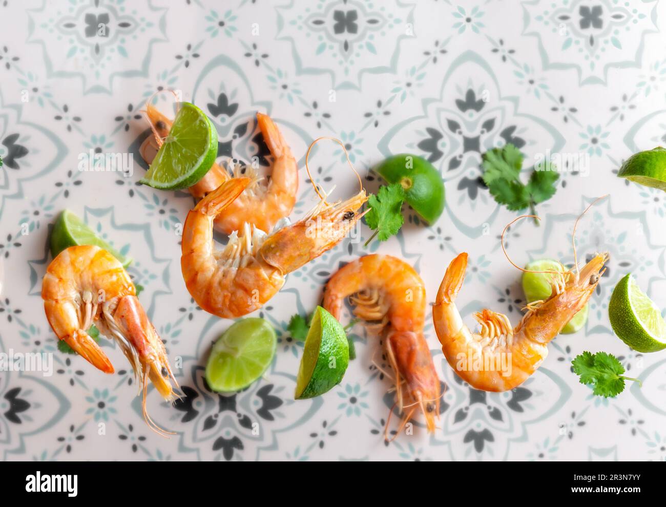 Flying food. Seafood shrimps prawns with cilantro and lemon. Mexican ceramic background Stock Photo