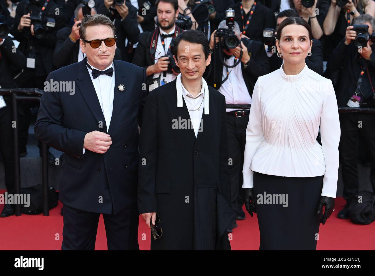 (left to right) Benoit Magimel, Tran Anh Hung and Juliette Binoche attending the premiere for La Passion de Dodin Bouffant during the 76th Cannes Film Festival in Cannes, France. Picture date: Wednesday May 24, 2023. Photo credit should read: Doug Peters/PA Wire Stock Photo