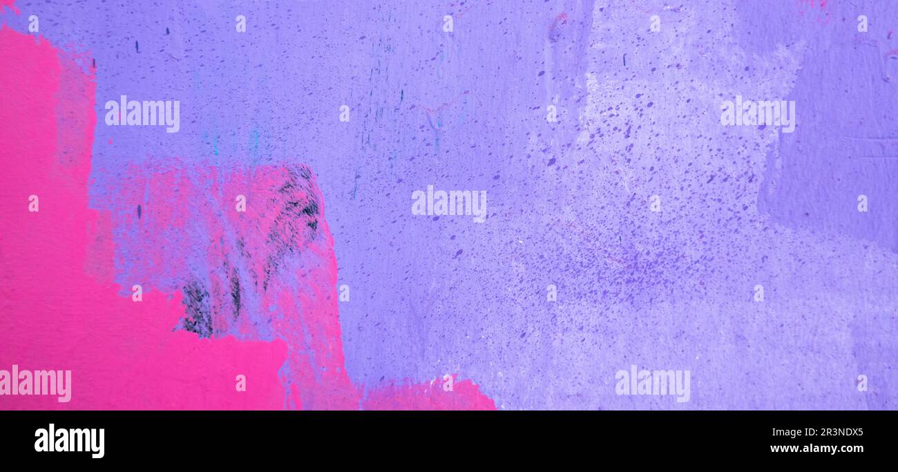 Purple paint strokes and smudges on an pink painted wall background ...