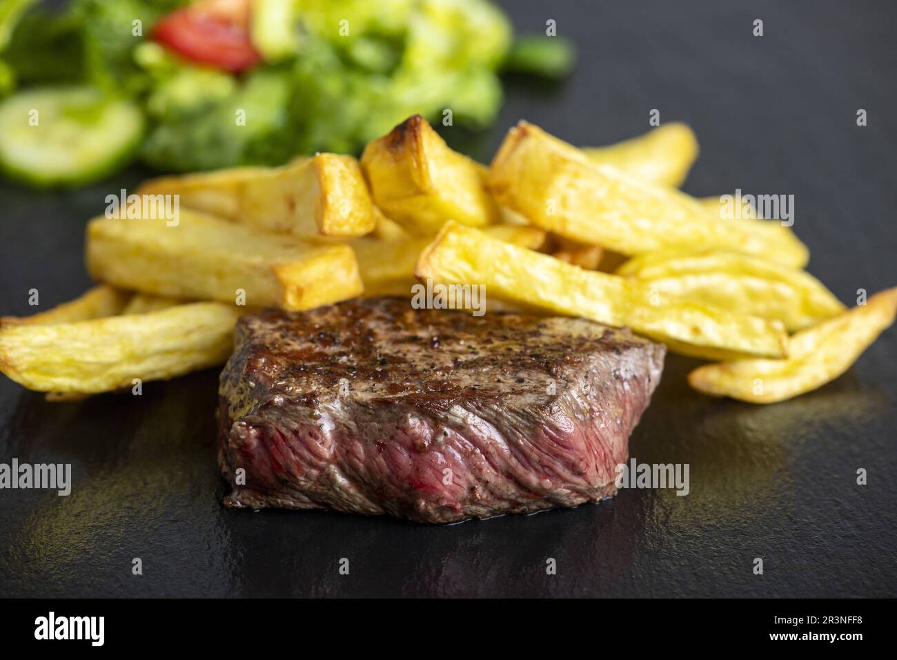 Steak with fries on slate Stock Photo