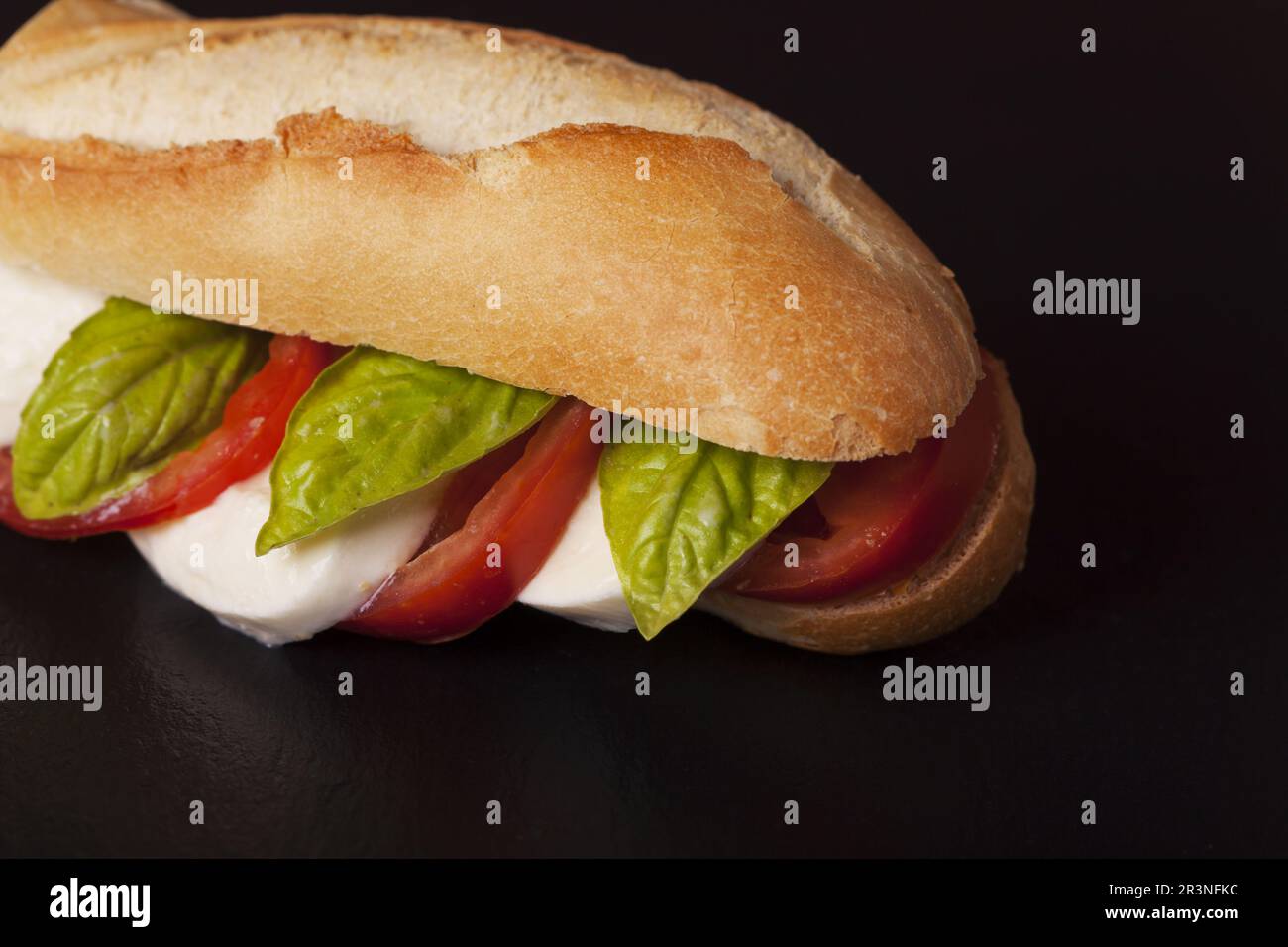 Italian mozarella tomato sandwich on slate Stock Photo
