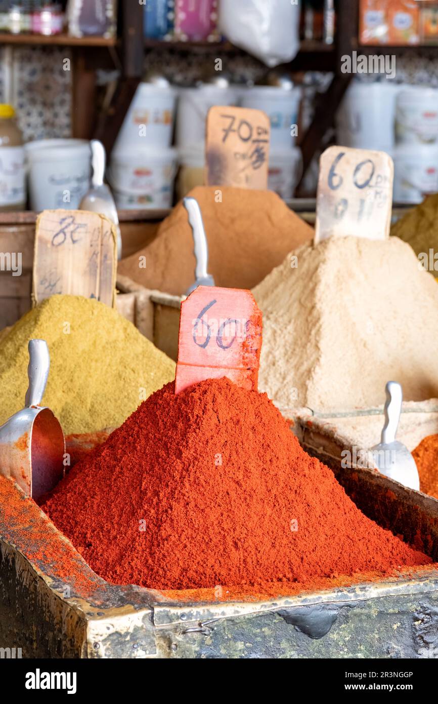Loose spices for sale in the spice market, La Mellah in the jewish quarter of Marrakesh. The spices are in colourful piles and shown with price labels Stock Photo