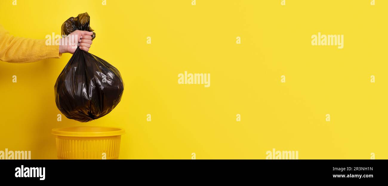 Hand holding garbage bag  panoramic Stock Photo