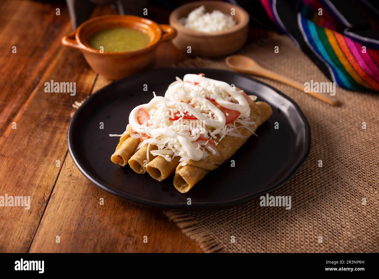 Tacos Dorados. Mexican dish also known as Flautas, consists of a rolled corn tortilla with some filling, commonly chicken or beef or vegetarian option Stock Photo
