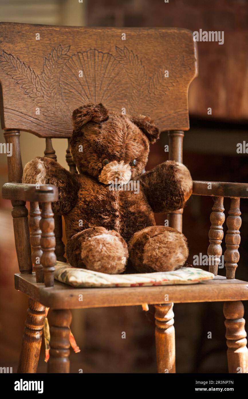 Teddy bear in high chair Stock Photo Alamy