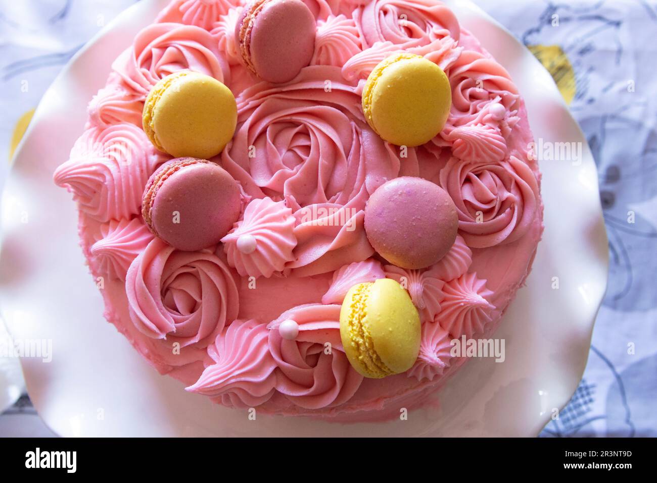 Pink raspberry cake with macarons Stock Photo - Alamy