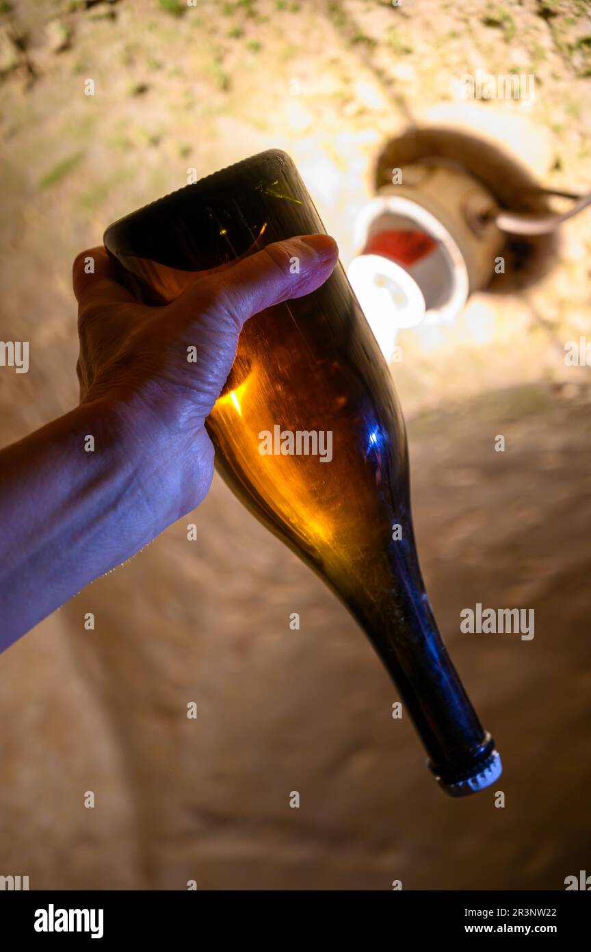 Checking of sediment in undergrounds caves with bottles on wooden racks