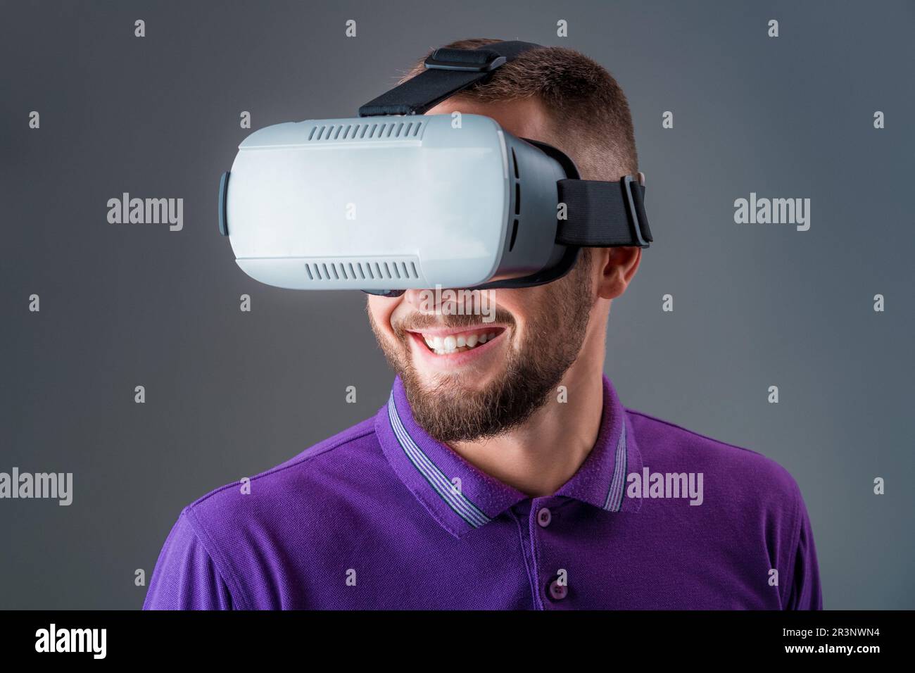 Man in studio wearing virtual reality headset playing game Stock Photo ...