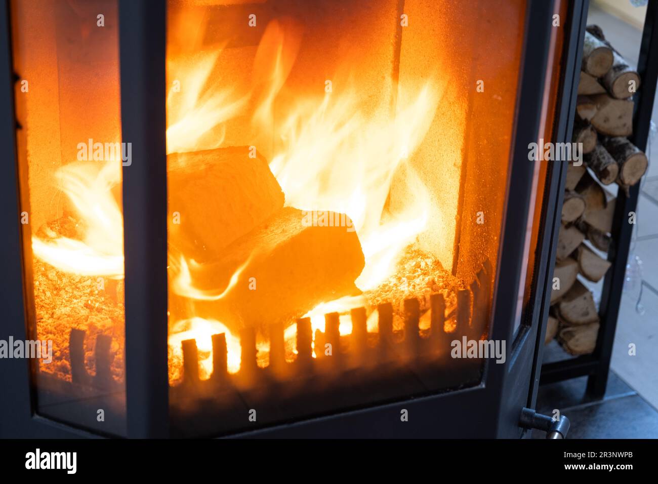 Fuel briquettes made of pressed sawdust for kindling the furnace - economical alternative eco-friendly fuel for the fireplace in Stock Photo