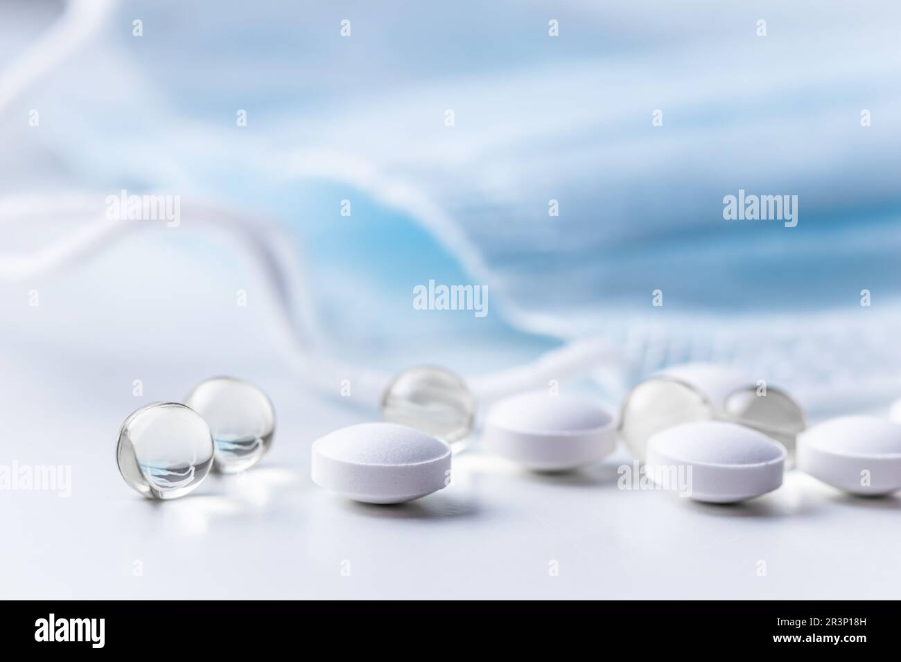 Capsules, pills and medical masks on white background. Health care, medical, pharmacy and illness concept Stock Photo