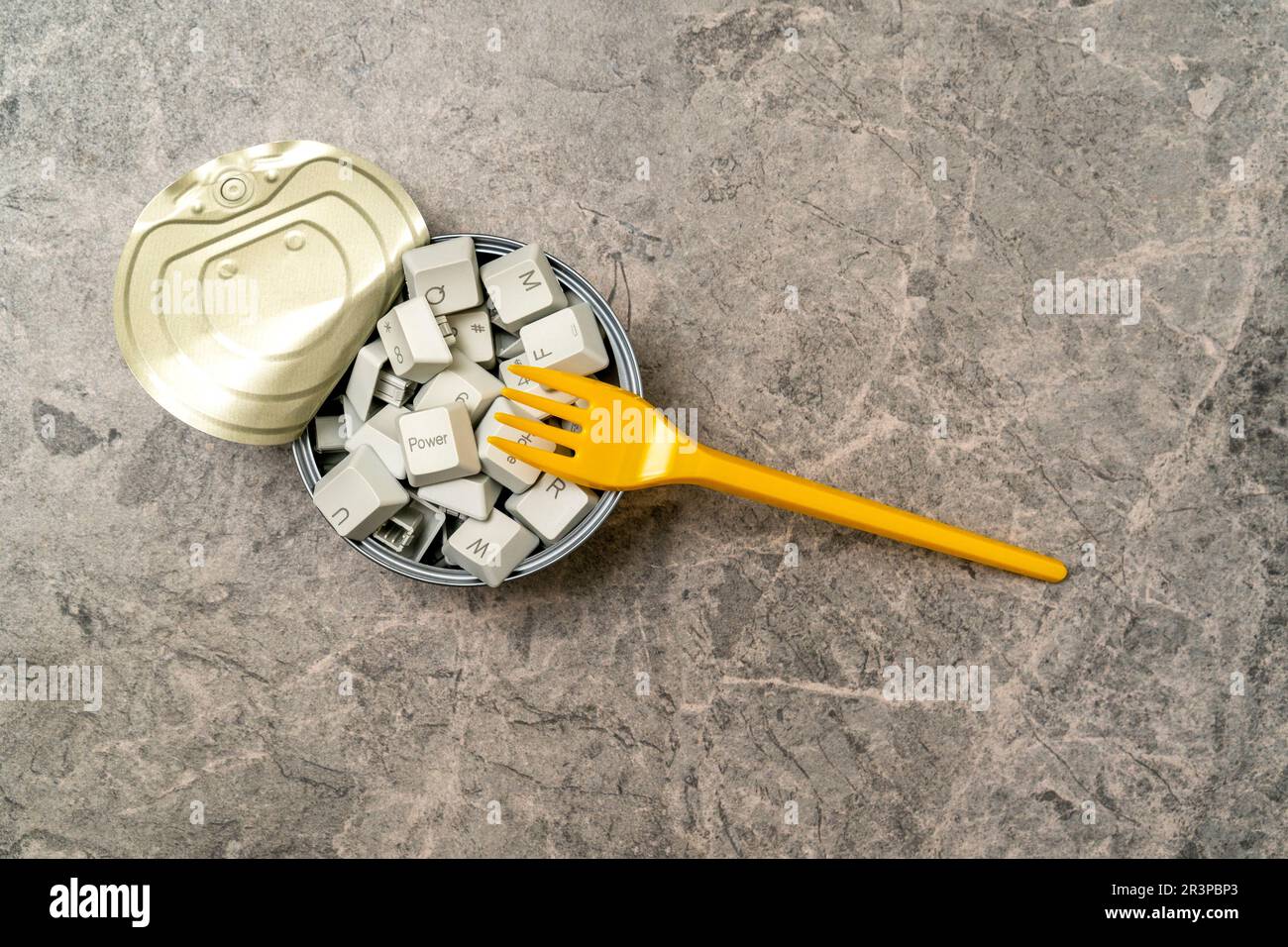 Yellow fork and tin can full of computer keyboard keys Stock Photo Alamy