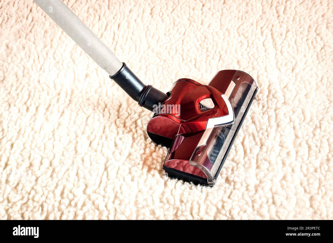 Home cleaning concept with vacuum cleaner. Red vacuum cleaner on a
