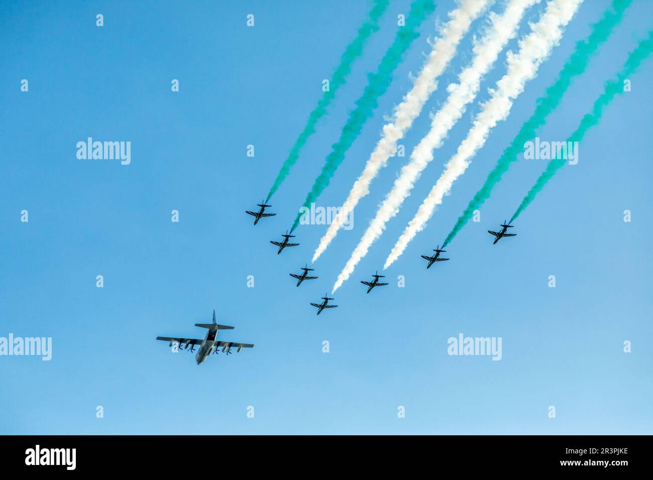 Bomber leading fighter jets squadron with traces in Saudi Arabian national flag colors, at Jeddah air show Stock Photo