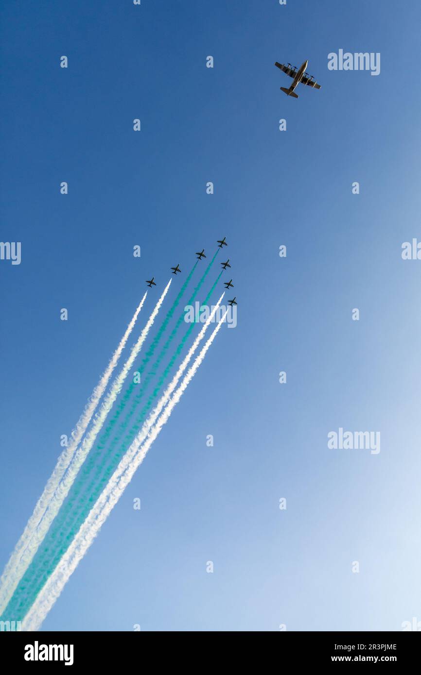 Bomber leading fighter jets squadron with traces in Saudi Arabian national flag colors, at Jeddah air show Stock Photo