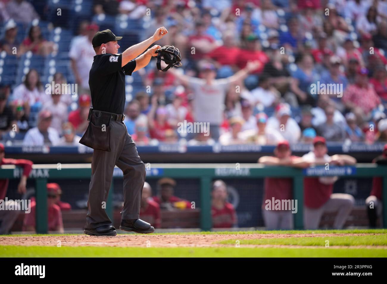 Umpire Junior Valentine signals a pitch clock violation during a