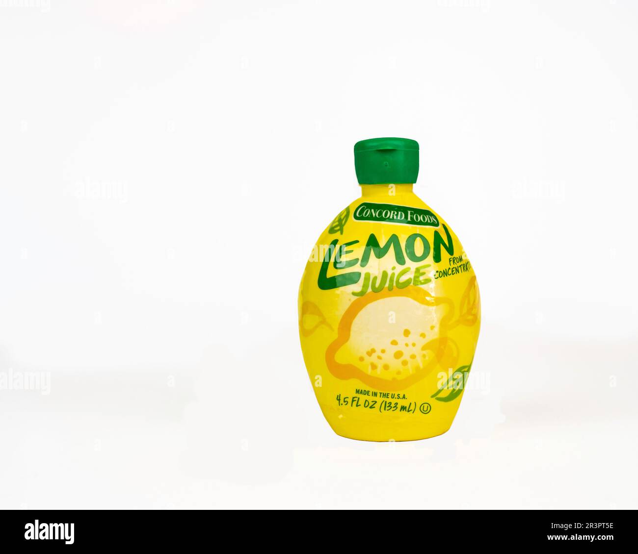 A plastic squeeze bottle with a flip-top lid of Concord Foods Lemon Juice from concentrate on a white background, USA. Stock Photo