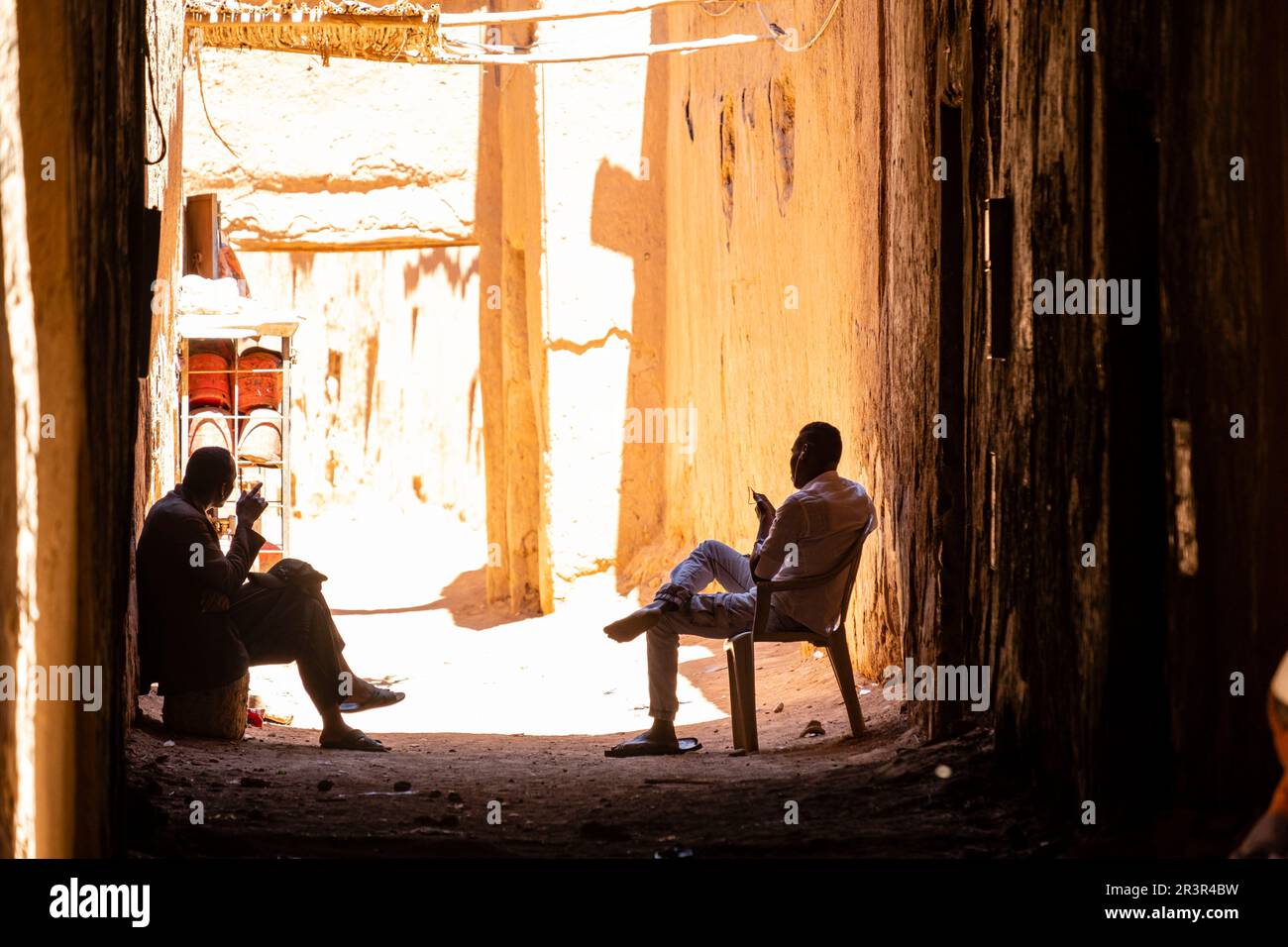 two men in the shade, ksar of Tamegroute, Draa Valley, Morocco, Africa. Stock Photo