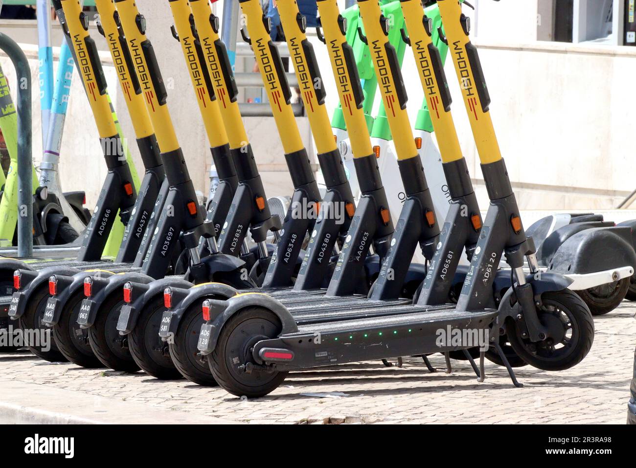 Whoosh E-Scooters parked in a regimented line awaiting hire in Lisbon,  Portugal. Other E-Scooter brands are also vailable brands, as are E-bikes  Stock Photo - Alamy