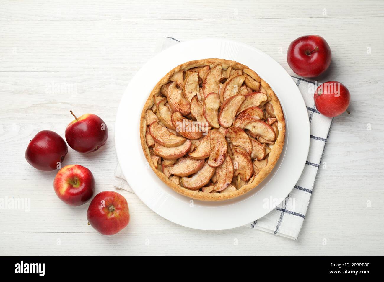 Delicious apple pie and fresh fruits on white wooden table, flat lay Stock Photo