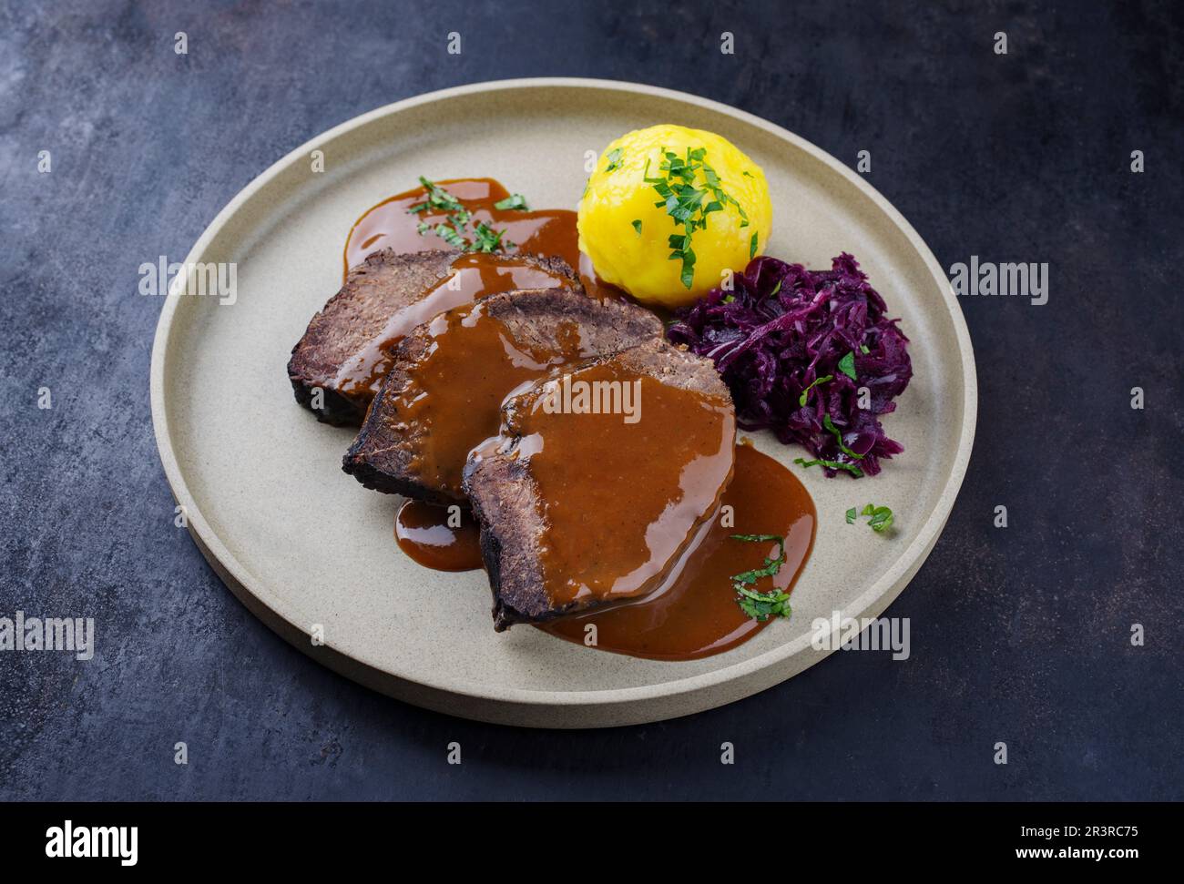 Traditional braised marinated German Sauerbraten from beef with blue