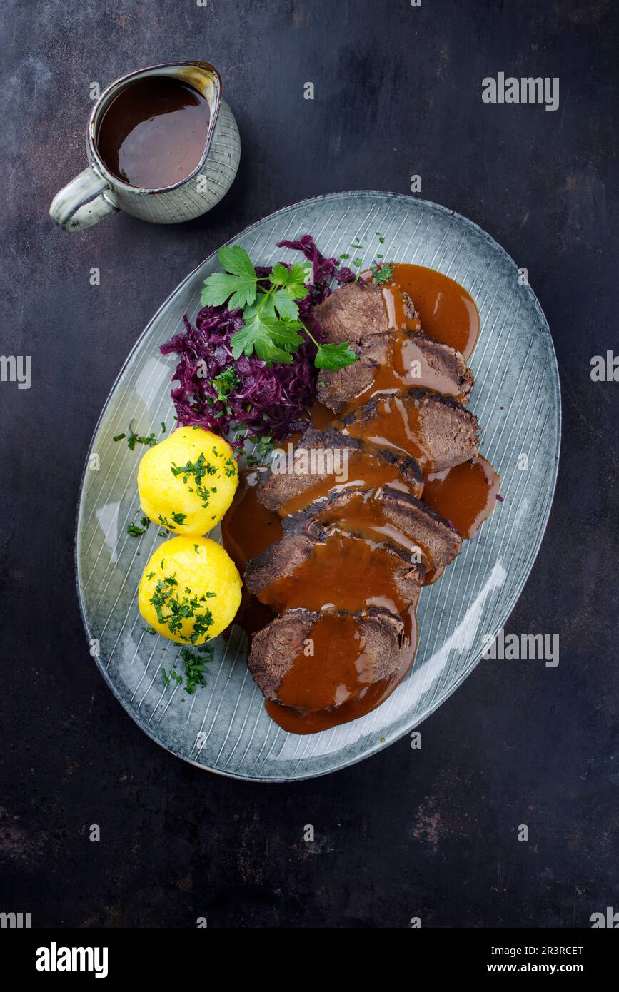 Traditional braised marinated German Sauerbraten from beef with blue