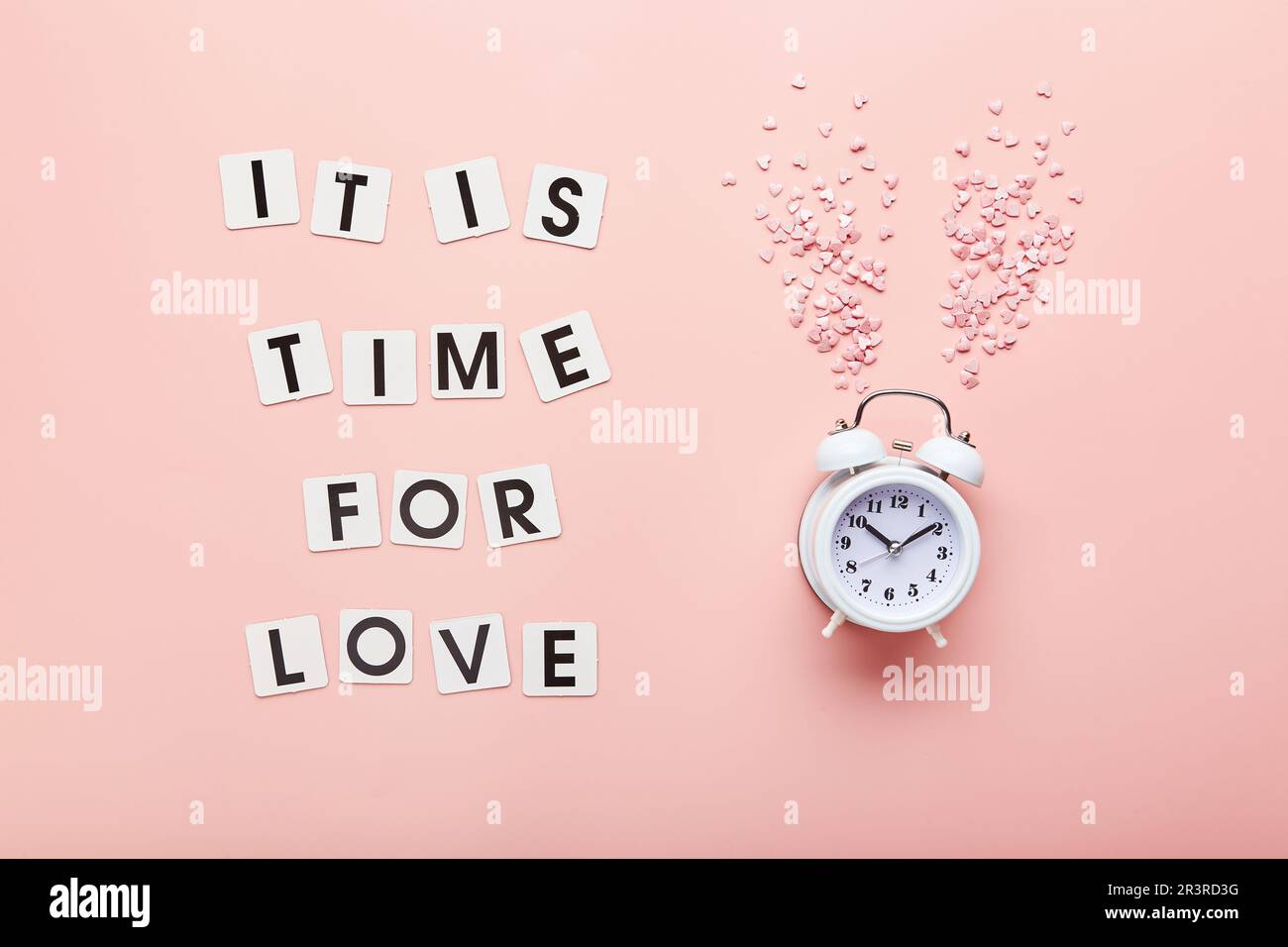 Letters and white alarm clock and pink hearts on pink background. Top ...