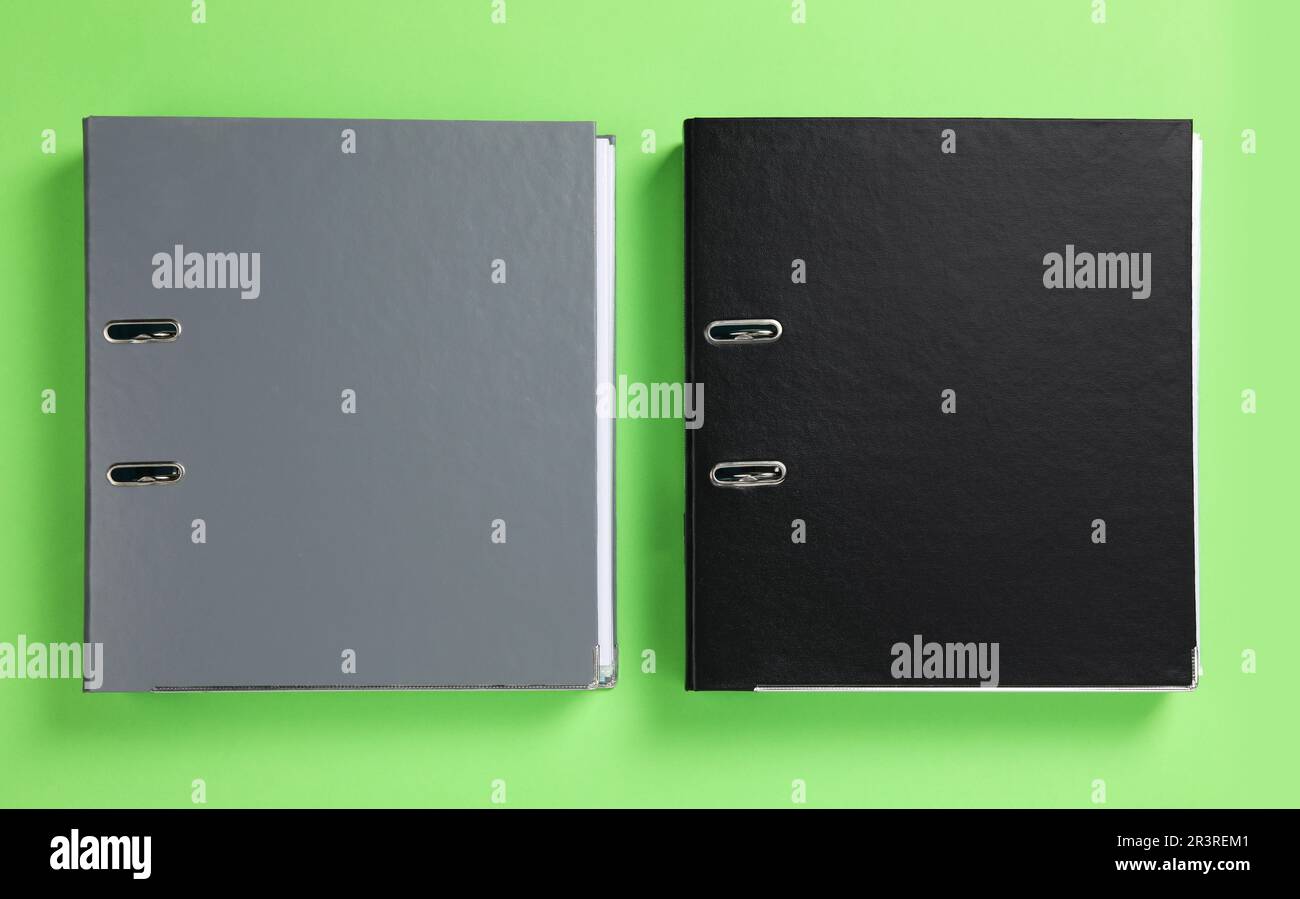 Office folders on light green background, flat lay Stock Photo