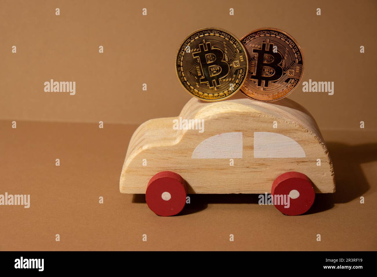 Bitcoin gold coin with wooden toy car. Saving and manage money for transport car loan mining trading concept. Automotive transportation industry merge with technology exchange financial market can pay money to seller online in blockchain. BTC Cryptocurrency or crypto digital payment system. Digital coin money farm in digital cyberspace Stock Photo