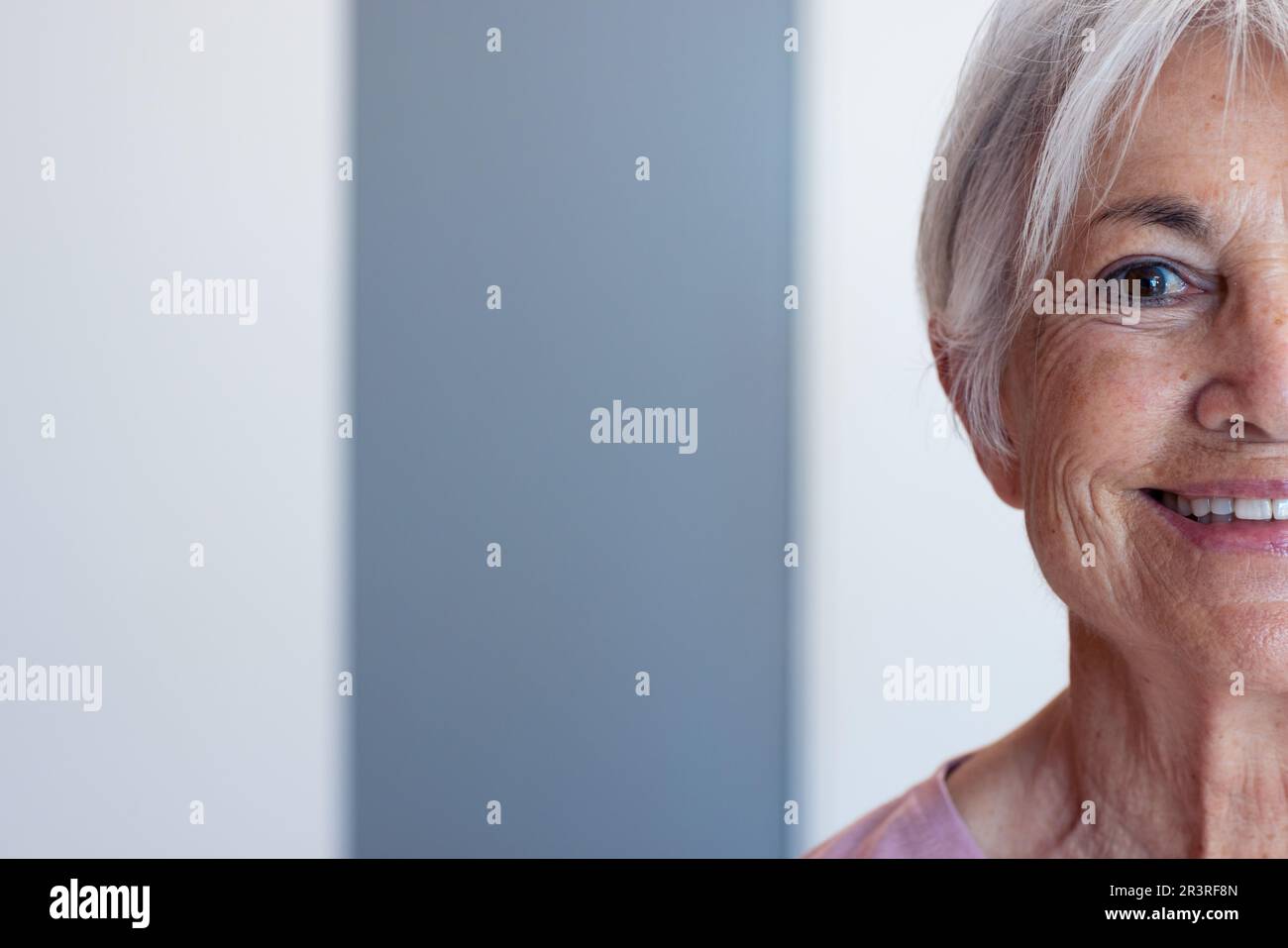 Half face portrait of smiling senior caucasian female patient in hospital, with copy space Stock Photo