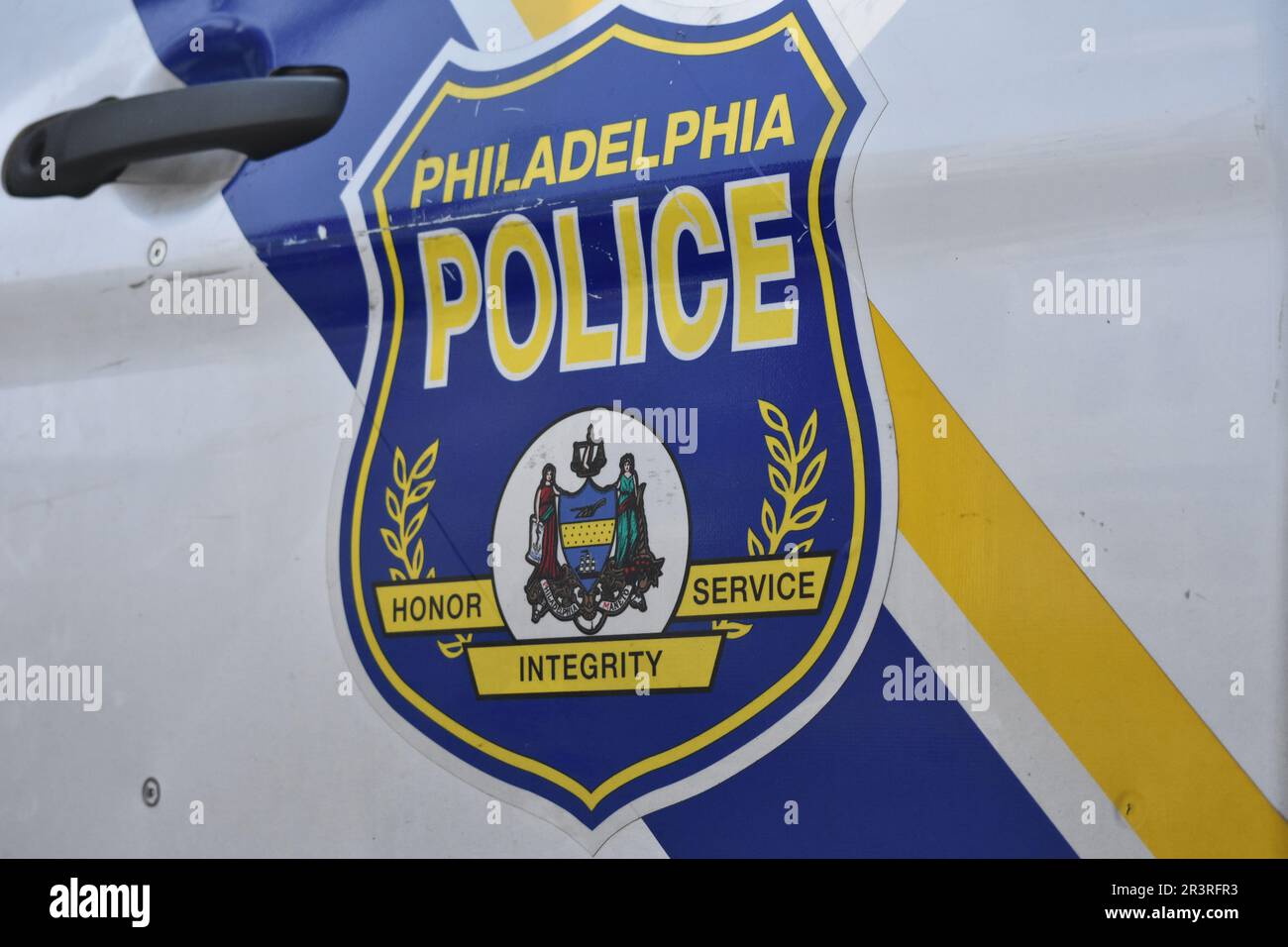 Philadelphia, Pennsylvania, United States, May 24, 2023. Philadelphia police logo and seal on a Philadelphia police cruiser at the crime scene. Two people shot, one person pronounced dead in a shooting in broad daylight in Philadelphia, Pennsylvania, United States on May 24, 2023. At 2:51 PM Eastern Time, Wednesday afternoon at the intersection of West Susquehanna Avenue and North Gratz Street, a 31-year-old black male was shot one time in the left arm, one time in the left side and one time in the back and was transported to the hospital by private automobile, he was later pronounced dead. Th Stock Photo