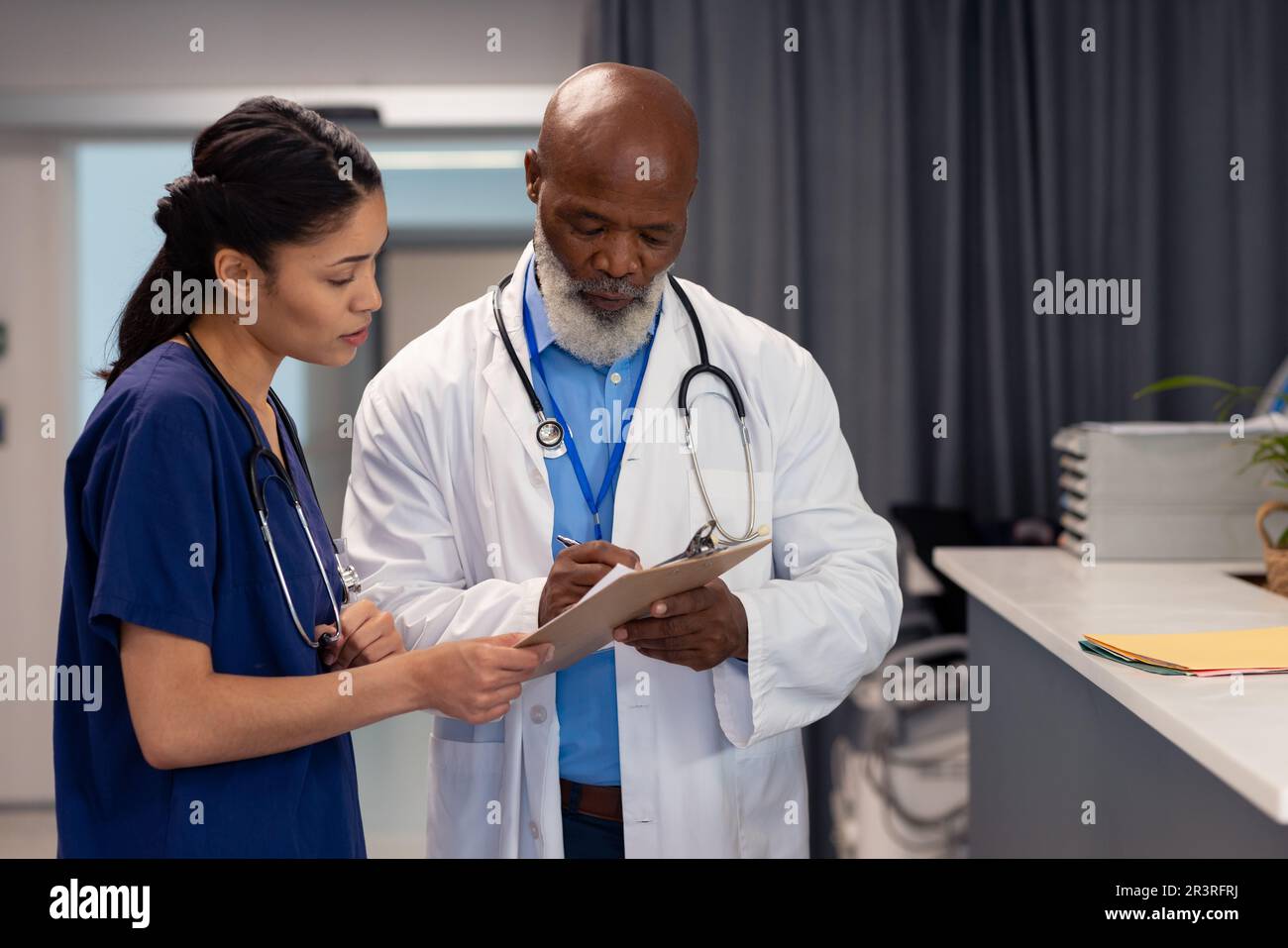 Diverse female doctor talking male hi-res stock photography and images ...