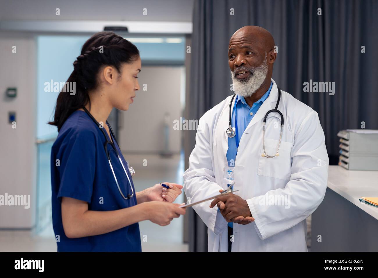 Diverse female doctor talking male hi-res stock photography and images ...