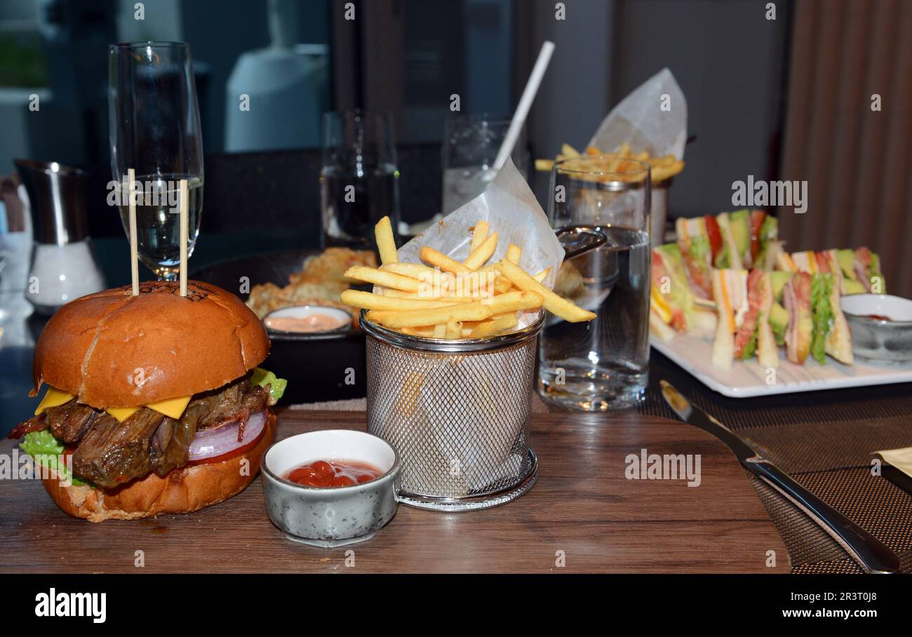 A slow cooked bee cheek burger with Fries Stock Photo Alamy