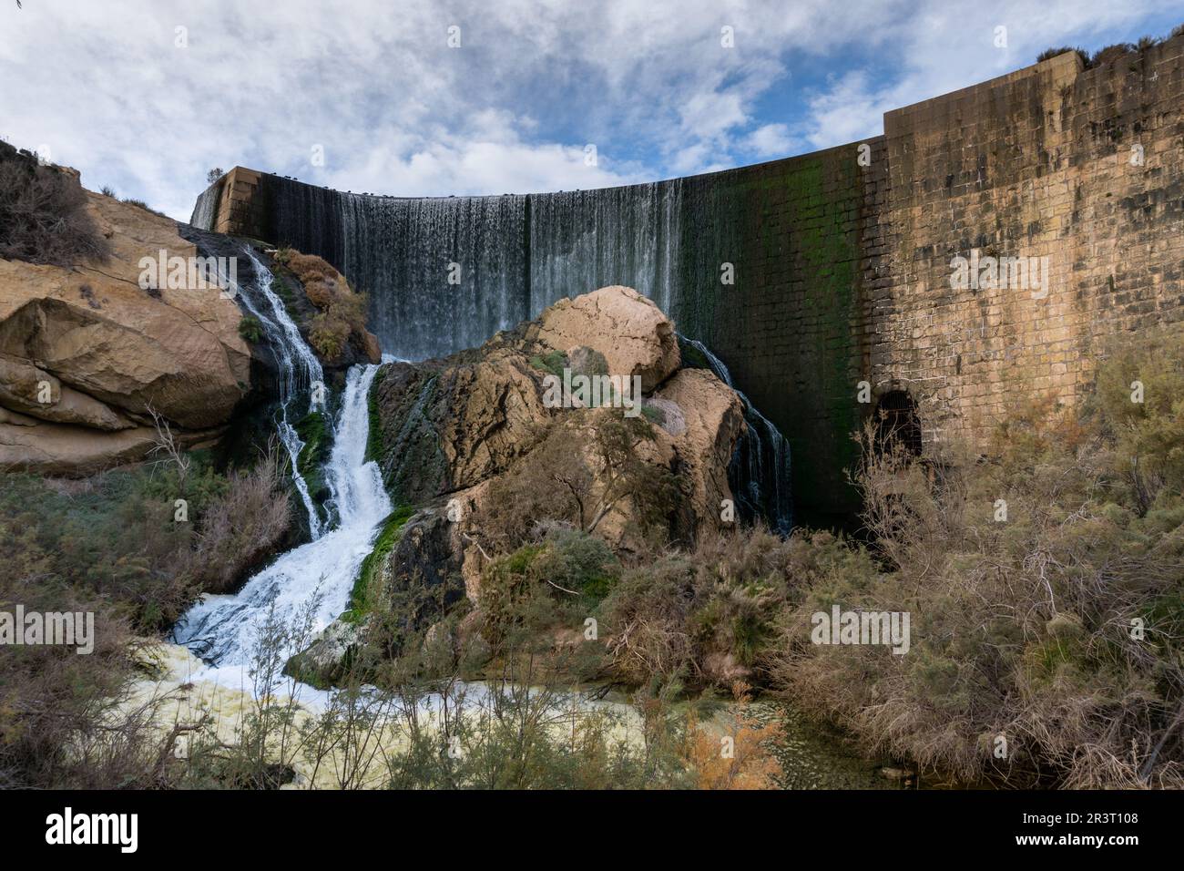 View of the waterfall and overflow of the dam wall of the Elche Reservoir Stock Photo