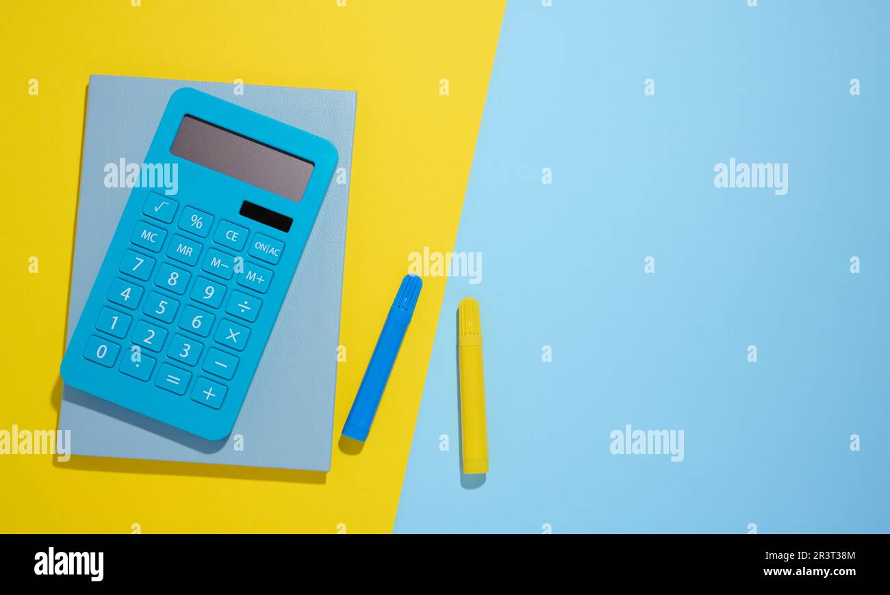 Blue notepad and markers on a blue background, top view Stock Photo
