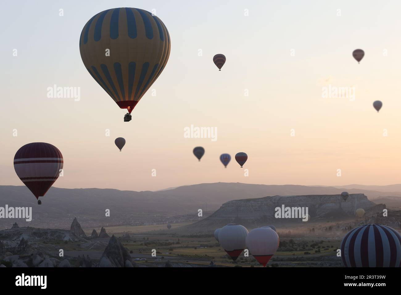 Colorful hot air balloons floating in air at bright sunrise Stock Photo ...