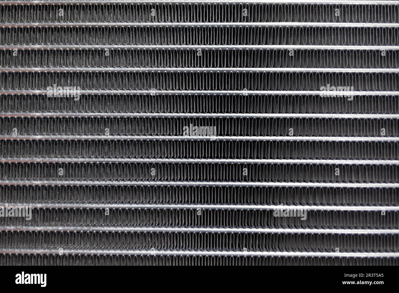 Texture of a car radiator. Engine cooler background. Vintage style. Radiator grille for car interior heater air conditioner, close-up. Radiator repair Stock Photo